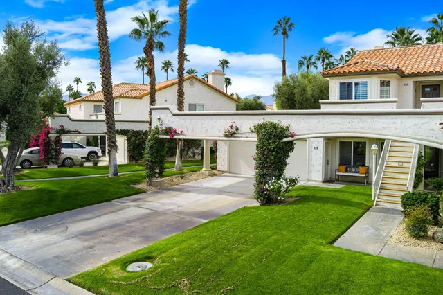 a view of a house with backyard and porch