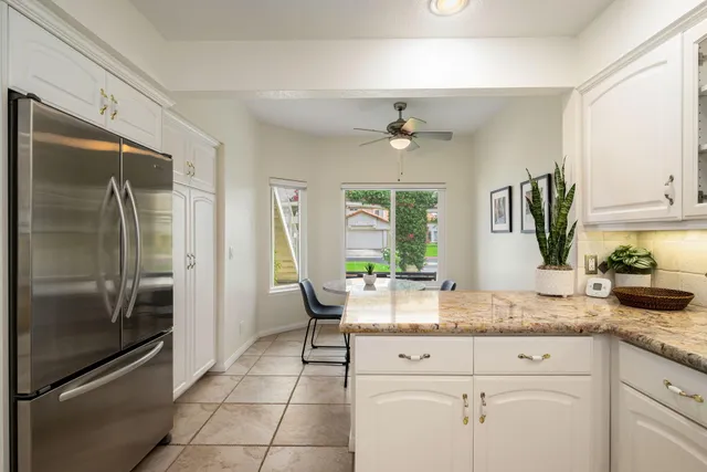 a kitchen with granite countertop cabinets stainless steel appliances and a sink
