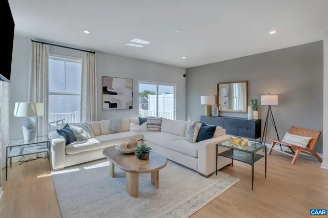 a living room with furniture or couch and a wooden floor