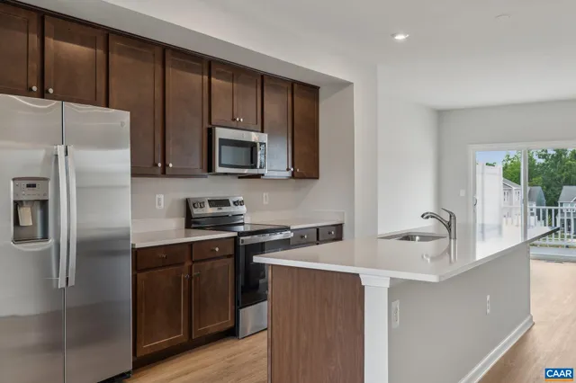 a kitchen with a refrigerator sink and microwave