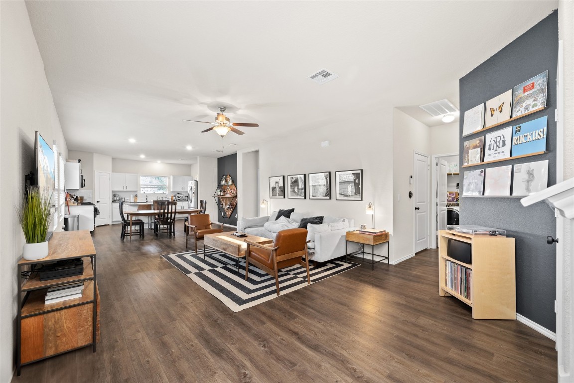 a living room with furniture fireplace and wooden floor