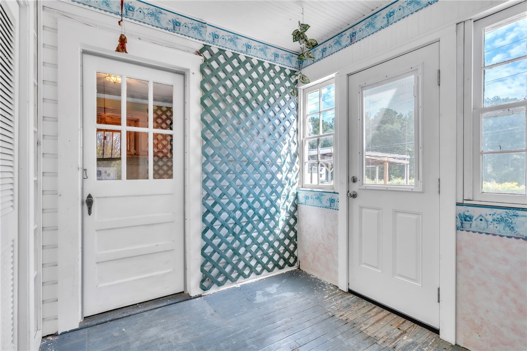 121 Ellison Street Belton, SC 29627 - Photo 19 of 30 This bright sunroom with classic wooden doors offers a welcoming entry to your home.
