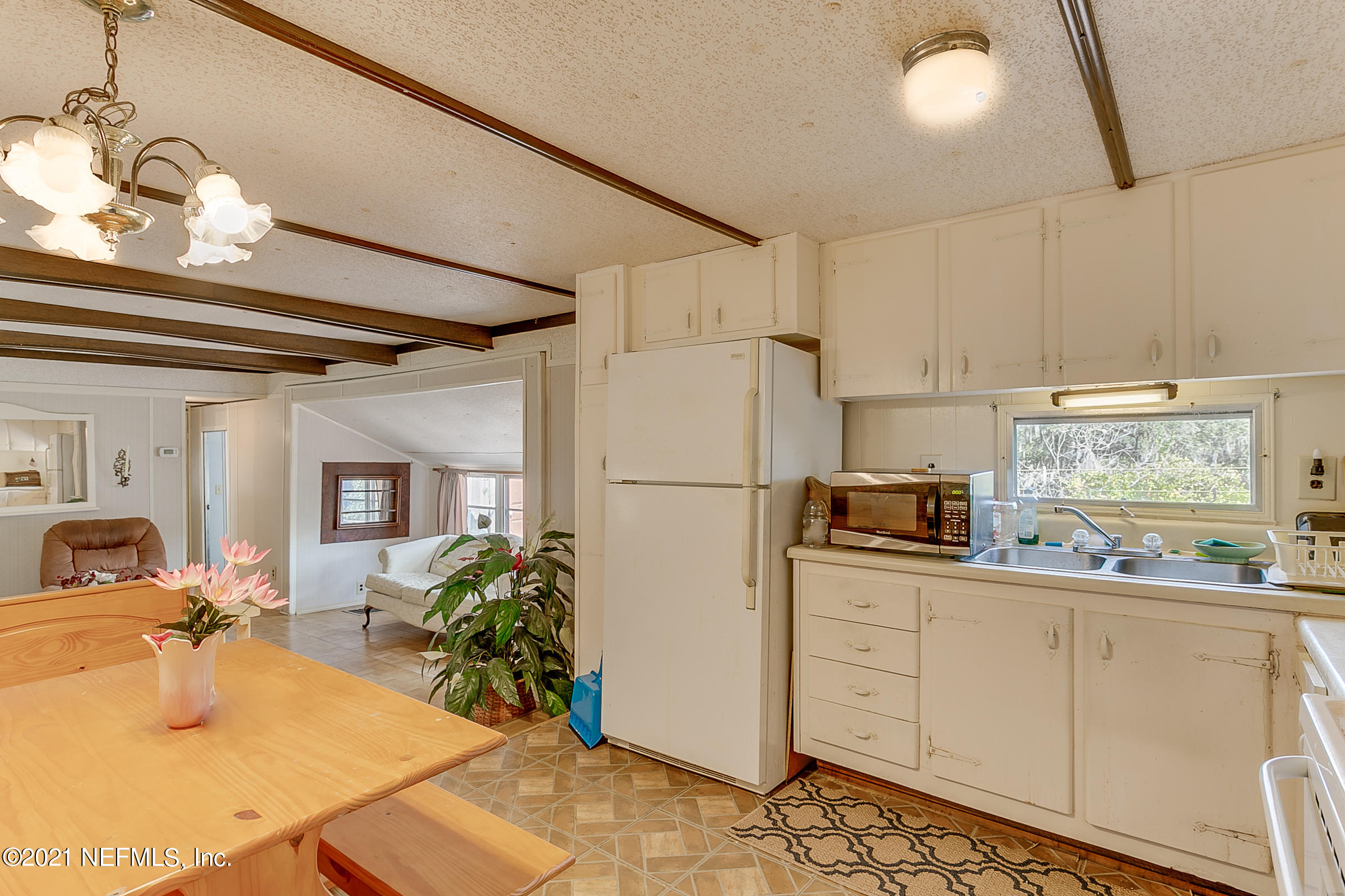 7004 Deer Springs Road Keystone Heights, FL 32656 - Photo 11 of 25 a kitchen with stainless steel appliances granite countertop a refrigerator and a sink
