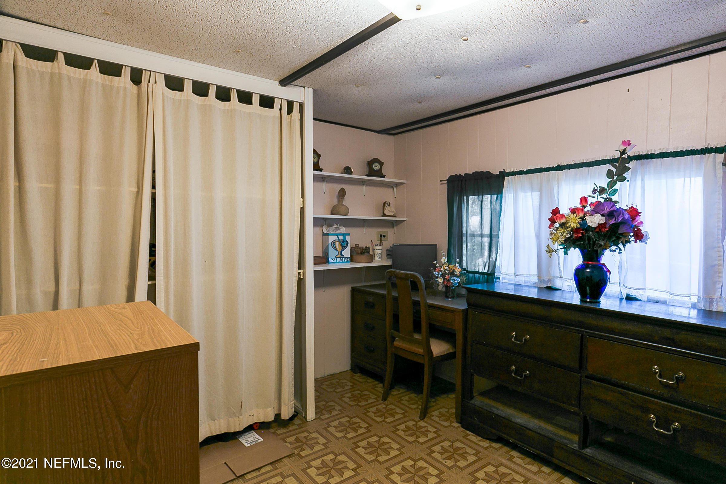 7004 Deer Springs Road Keystone Heights, FL 32656 - Photo 16 of 25 a kitchen with a refrigerator and a table in it