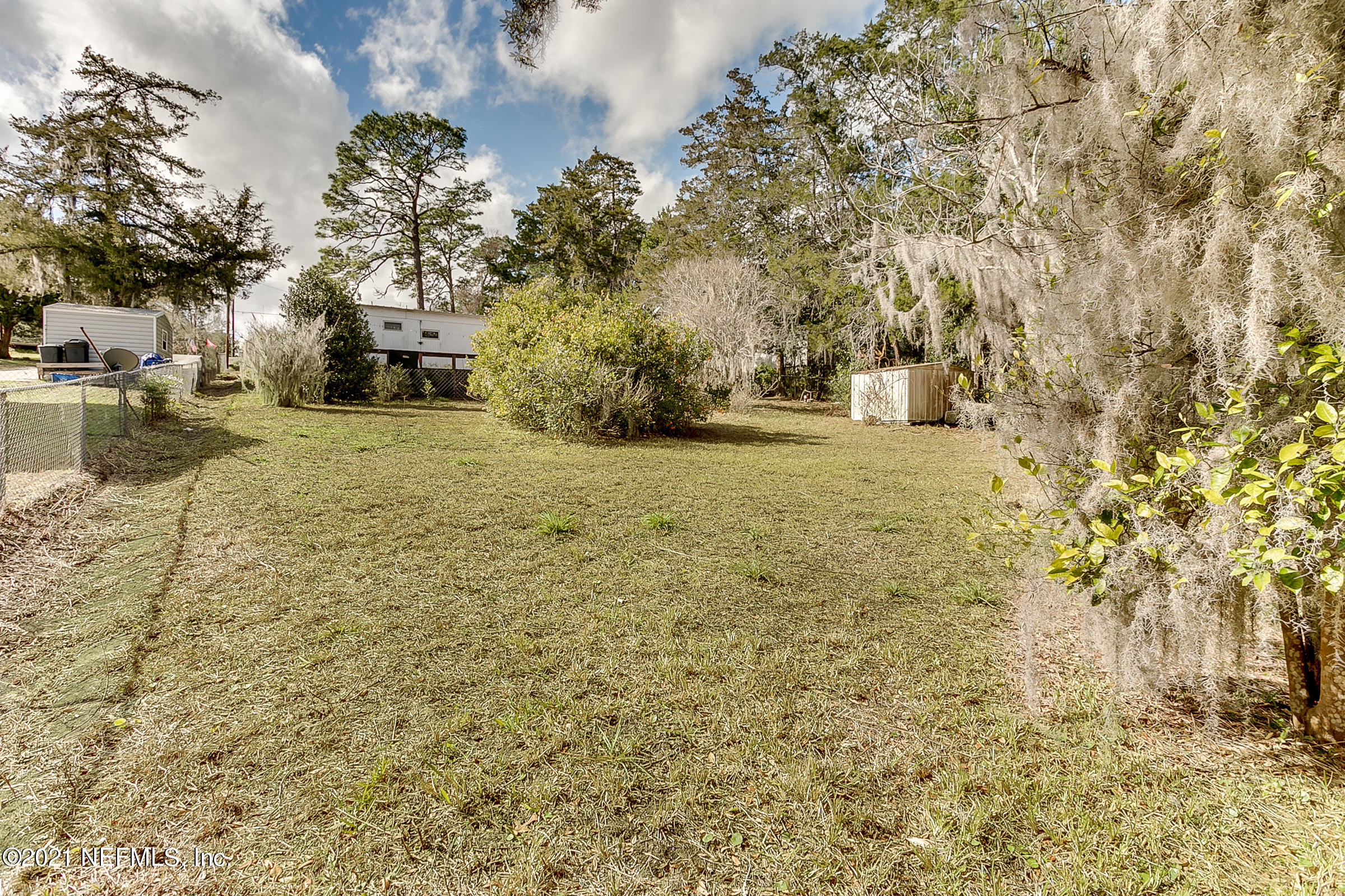 7004 Deer Springs Road Keystone Heights, FL 32656 - Photo 4 of 25 a street view with large trees