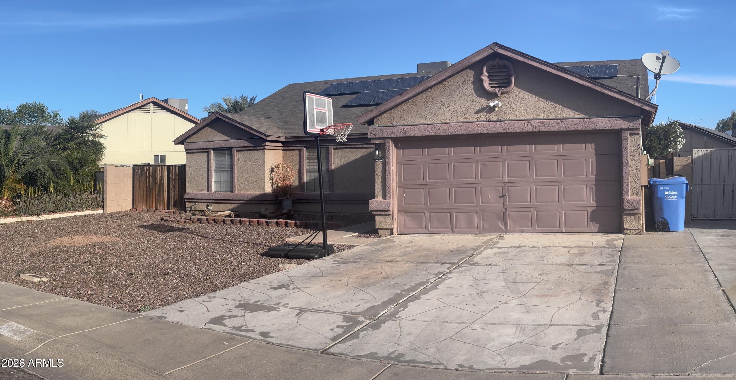 9002 West Coronado Road Phoenix, AZ 85037 - Photo 2 of 48 a front view of a house with a yard and garage