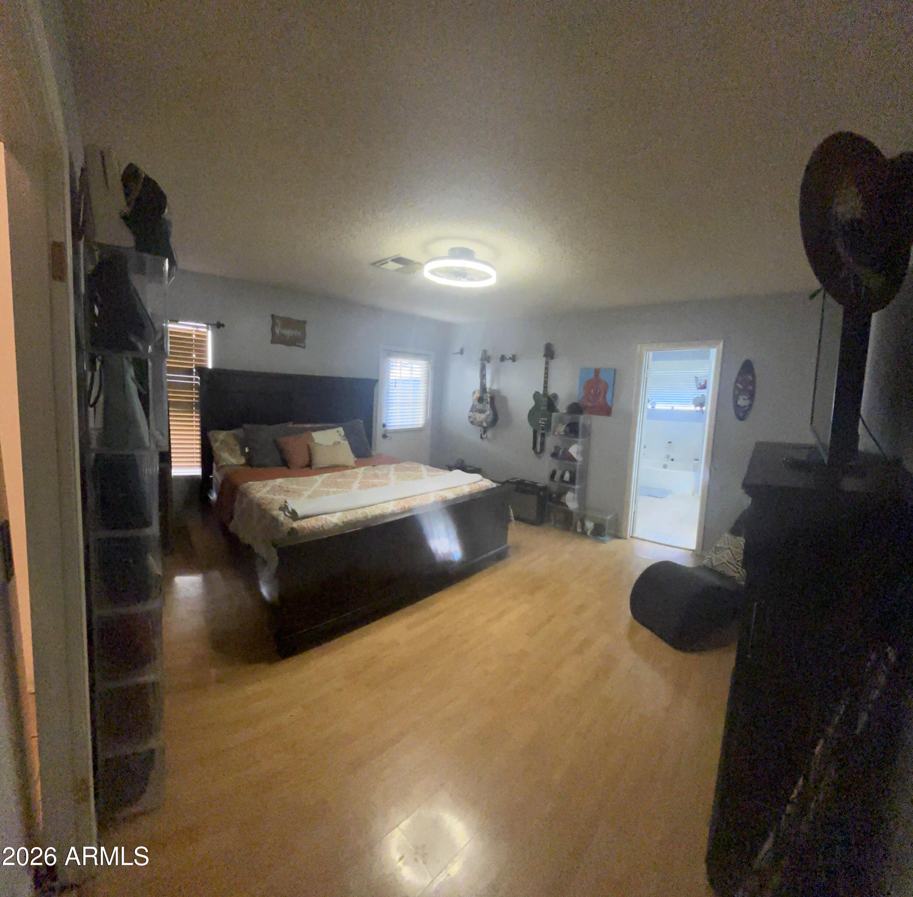 9002 West Coronado Road Phoenix, AZ 85037 - Photo 26 of 48 a bedroom with furniture and a wooden floor