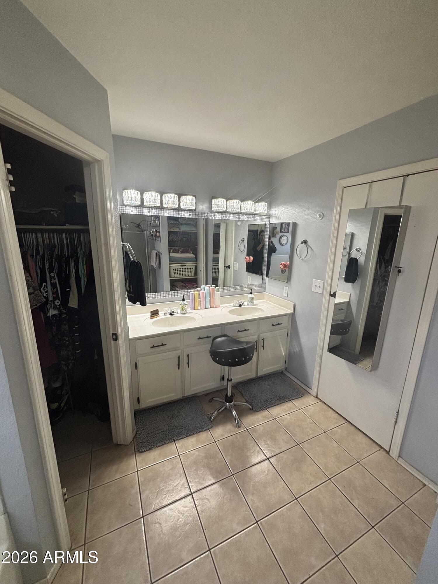 9002 West Coronado Road Phoenix, AZ 85037 - Photo 30 of 48 a room with a washing machine a sink a washer and dryer