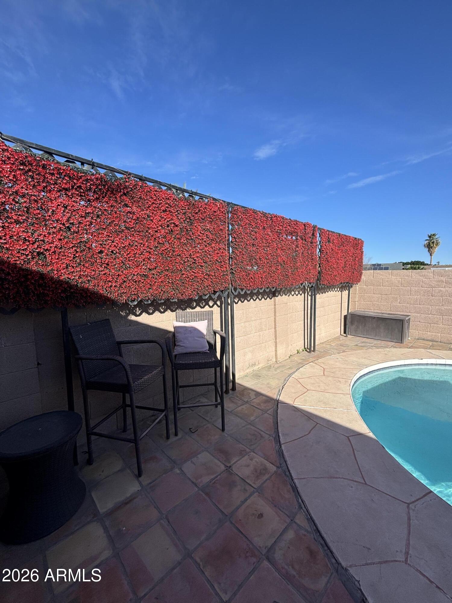 9002 West Coronado Road Phoenix, AZ 85037 - Photo 40 of 48 a backyard of a house with table and chairs