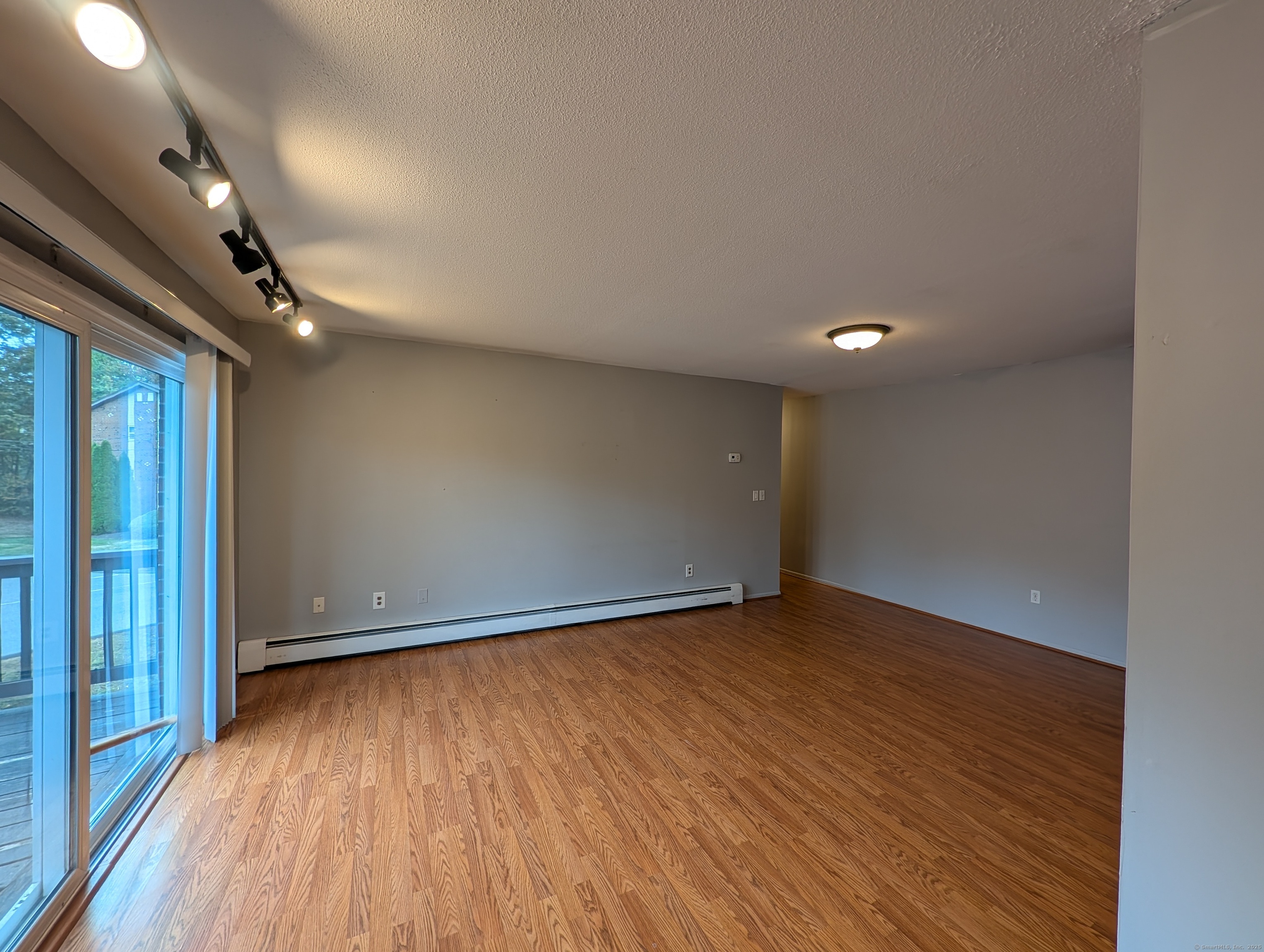 41 Balance Rock Road, Unit 16 Seymour, CT 06483 - Photo 4 of 13 an empty room with wooden floor and windows