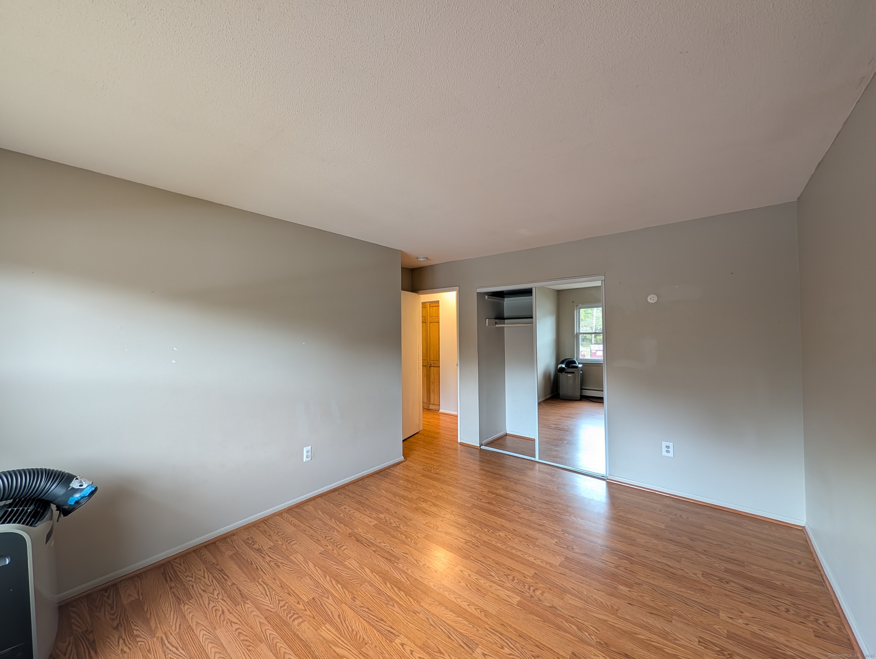 41 Balance Rock Road, Unit 16 Seymour, CT 06483 - Photo 8 of 13 a view of an empty room with window and wooden floor