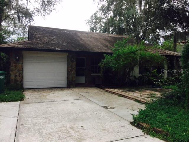 10212 North Hyaleah Road Tampa, FL 33617 - Photo 1 of 1 a front view of house with yard and trees