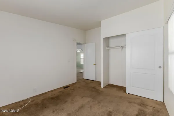 a view of an empty room with a flat screen tv and a window