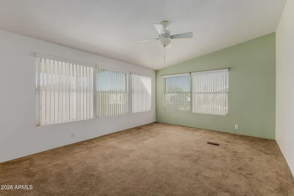 a view of a big room with closet and windows