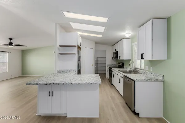 a kitchen with granite countertop a stove and a sink