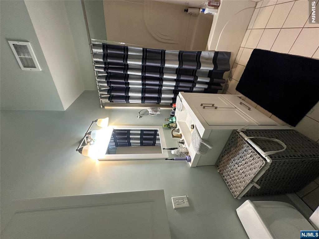 128 Locust Avenue, Unit D Wallington, NJ 07057 - Photo 8 of 8 a view of bathroom with a sink a toilet and shower