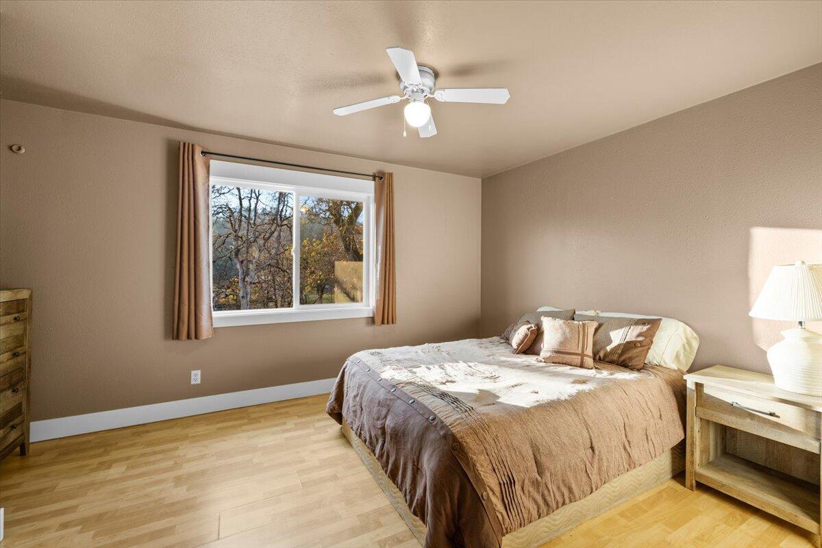1360 Oxyoke Road Grants Pass, OR 97526 - Photo 25 of 39 a bedroom with a bed and a window