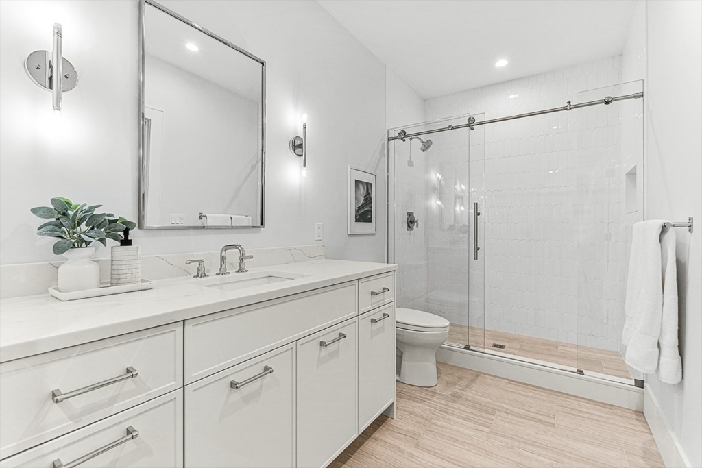 123 Lawton Road Needham, MA 02492 - Photo 13 of 16 a bathroom with a double vanity sink toilet and shower