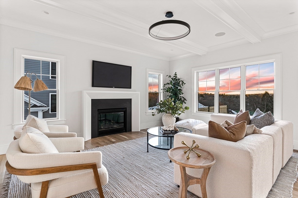 123 Lawton Road Needham, MA 02492 - Photo 4 of 16 a living room with furniture a fireplace and a large window