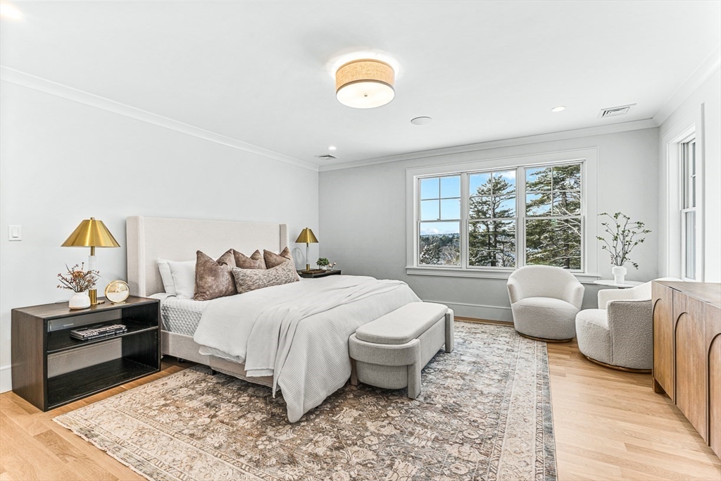 123 Lawton Road Needham, MA 02492 - Photo 7 of 16 a bedroom with a bed and wooden floor