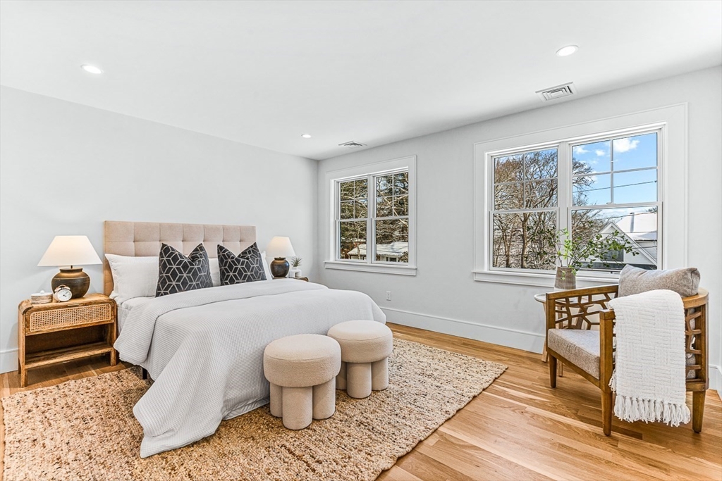 123 Lawton Road Needham, MA 02492 - Photo 10 of 16 a bedroom with a bed and wooden floor