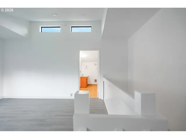 a view of an empty room and wooden floor