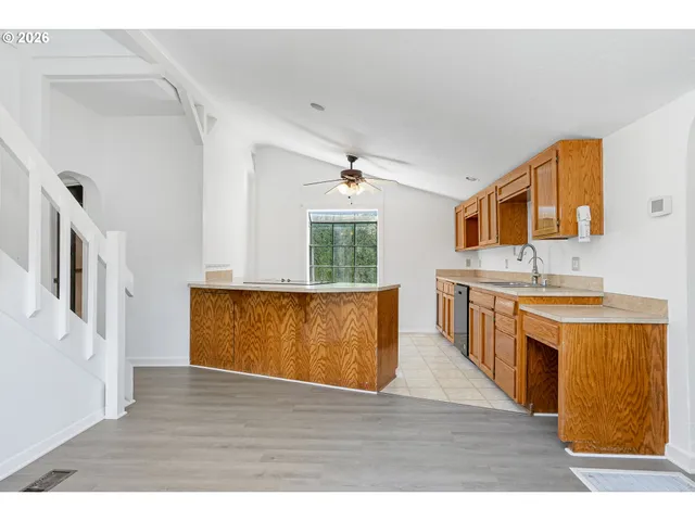 a kitchen with granite countertop a stove and a sink