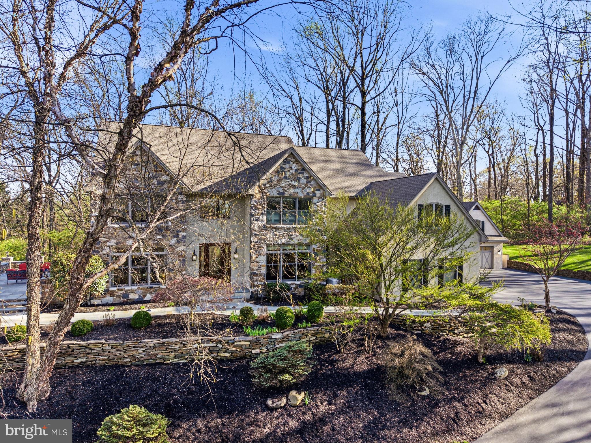 1714 Hickory Hill Road Chadds Ford, PA 19317 - Photo 2 of 82 a view of a white house with a yard covered in the forest