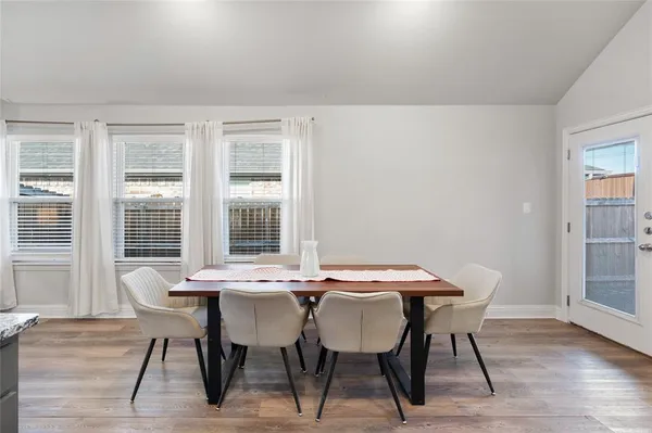 a view of a dining room with furniture and wooden floor