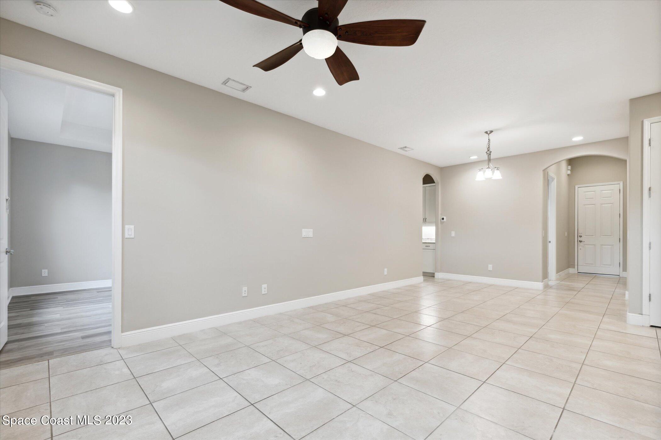 3611 Stabane Place Melbourne, FL 32940 - Photo 14 of 50 a view of an empty room and window a ceiling fan