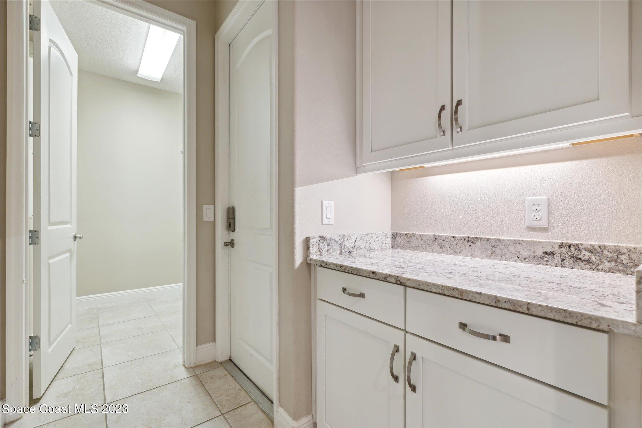 3611 Stabane Place Melbourne, FL 32940 - Photo 29 of 50 a bathroom with a granite countertop sink and a mirror