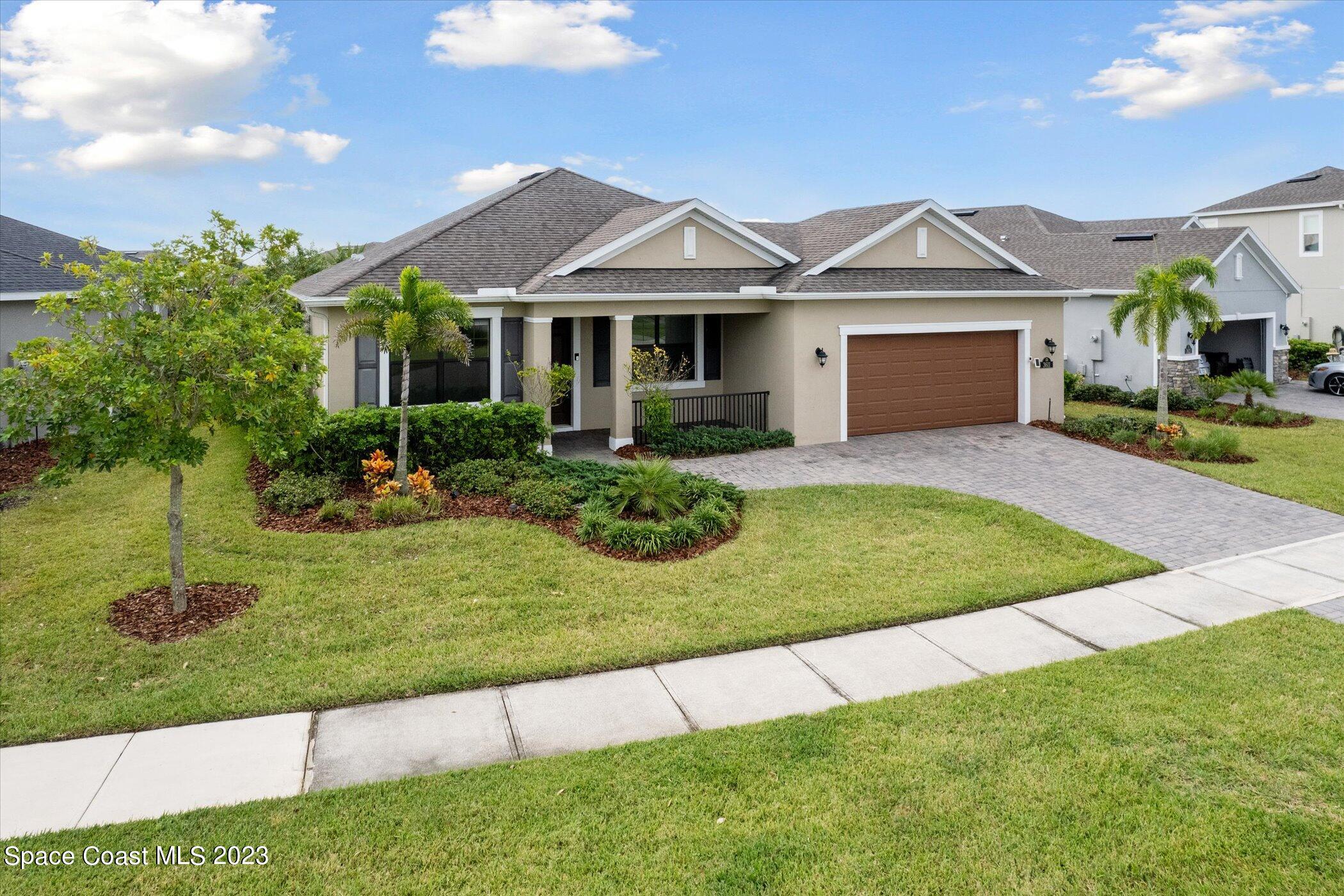 3611 Stabane Place Melbourne, FL 32940 - Photo 38 of 50 a front view of a house with a yard and garage