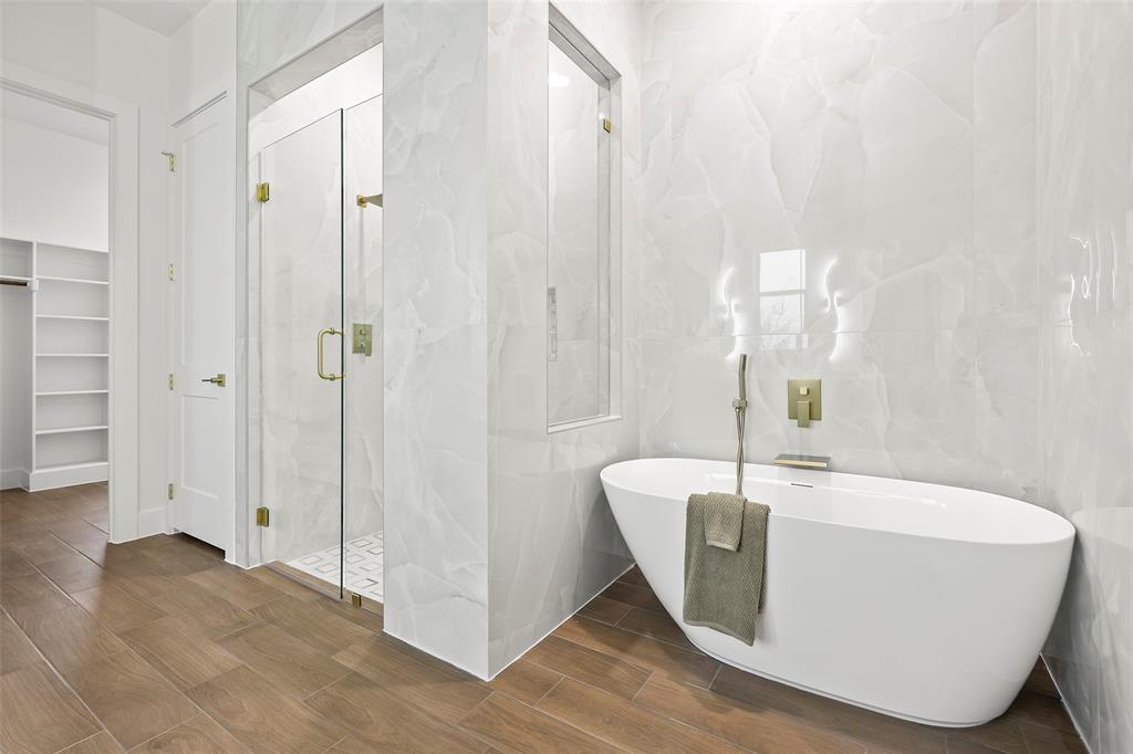 1000 Canyon Lake Road Wills Point, TX 75169 - Photo 10 of 40 Bathroom featuring wood finish floors, a marble finish shower, tile walls, and a freestanding bath