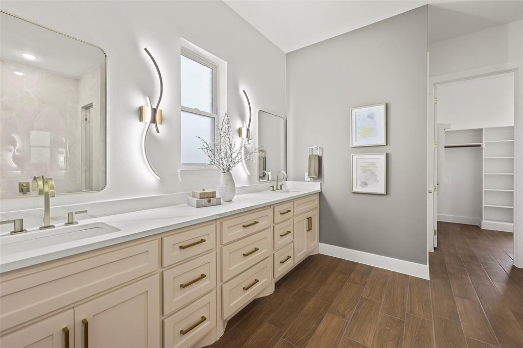 1000 Canyon Lake Road Wills Point, TX 75169 - Photo 13 of 40 Bathroom featuring a sink, double vanity, wood finished floors, and baseboards