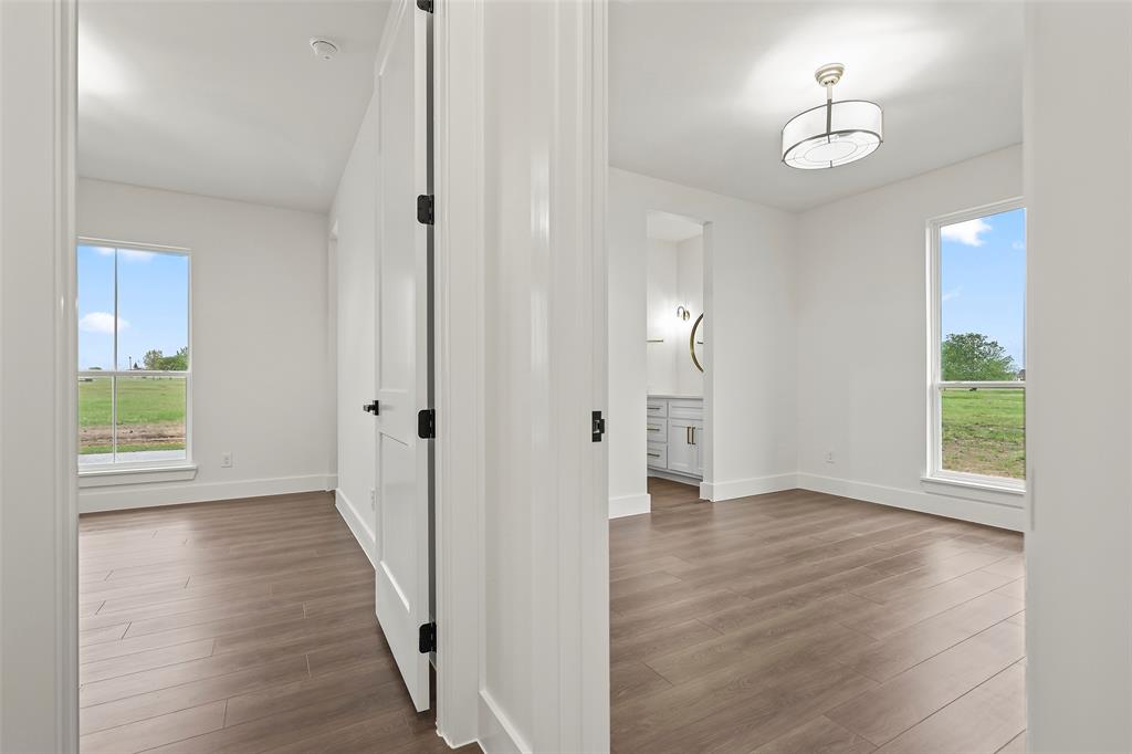 1000 Canyon Lake Road Wills Point, TX 75169 - Photo 17 of 40 Hall featuring baseboards, a wealth of natural light, and wood finished floors