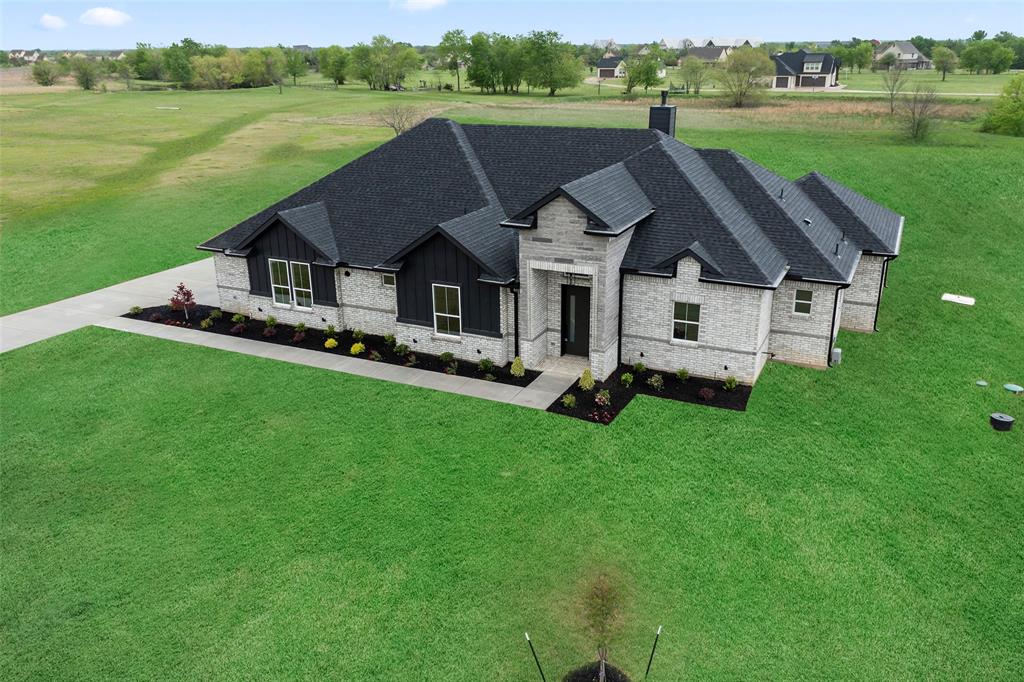1000 Canyon Lake Road Wills Point, TX 75169 - Photo 2 of 40 French provincial home featuring stone siding, a front lawn, board and batten siding, and roof with shingles