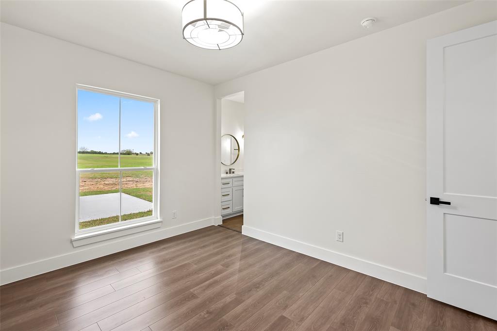 1000 Canyon Lake Road Wills Point, TX 75169 - Photo 22 of 40 Spare room with dark wood-style flooring and baseboards