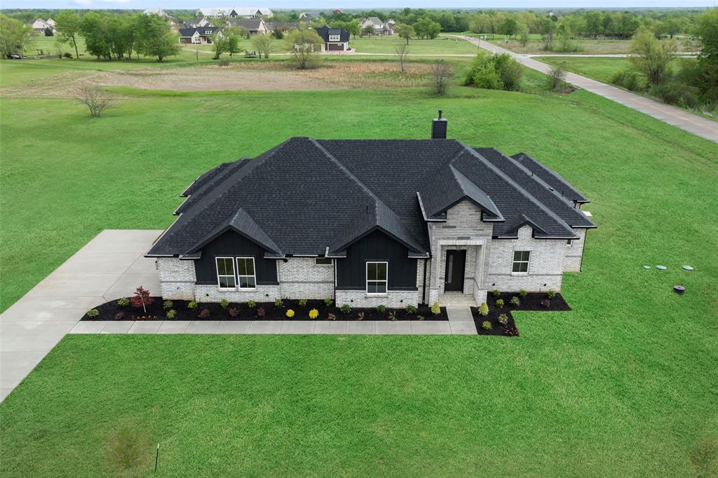 1000 Canyon Lake Road Wills Point, TX 75169 - Photo 30 of 40 View of front of home featuring brick siding, a front yard, a shingled roof, and a chimney