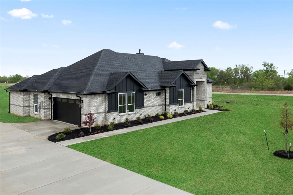 1000 Canyon Lake Road Wills Point, TX 75169 - Photo 37 of 40 View of front of property with brick siding, driveway, a front yard, and board and batten siding