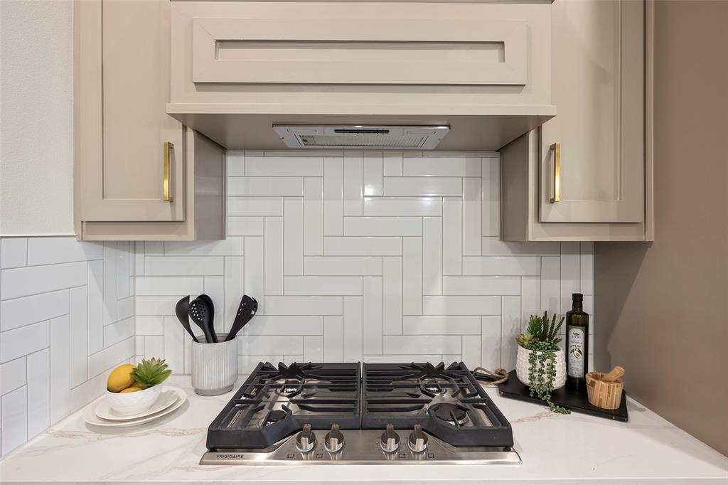 1000 Canyon Lake Road Wills Point, TX 75169 - Photo 3 of 40 Kitchen with stainless steel gas stovetop, light stone counters, decorative backsplash, and range hood