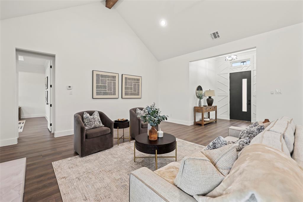 1000 Canyon Lake Road Wills Point, TX 75169 - Photo 6 of 40 Living area featuring high vaulted ceiling, visible vents, baseboards, beamed ceiling, and dark wood-type flooring