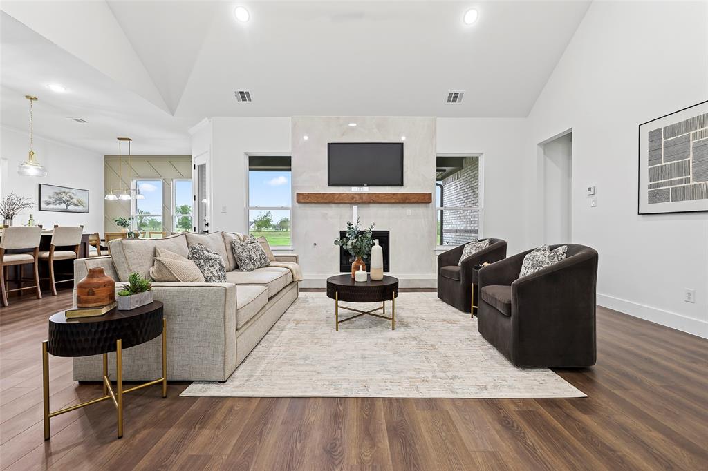 1000 Canyon Lake Road Wills Point, TX 75169 - Photo 7 of 40 Living area featuring baseboards, visible vents, wood finished floors, and a fireplace