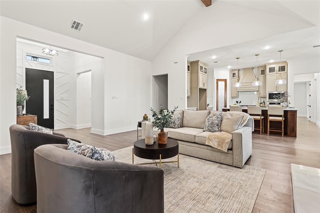 1000 Canyon Lake Road Wills Point, TX 75169 - Photo 8 of 40 Living area featuring baseboards, high vaulted ceiling, visible vents, and light wood-style floors