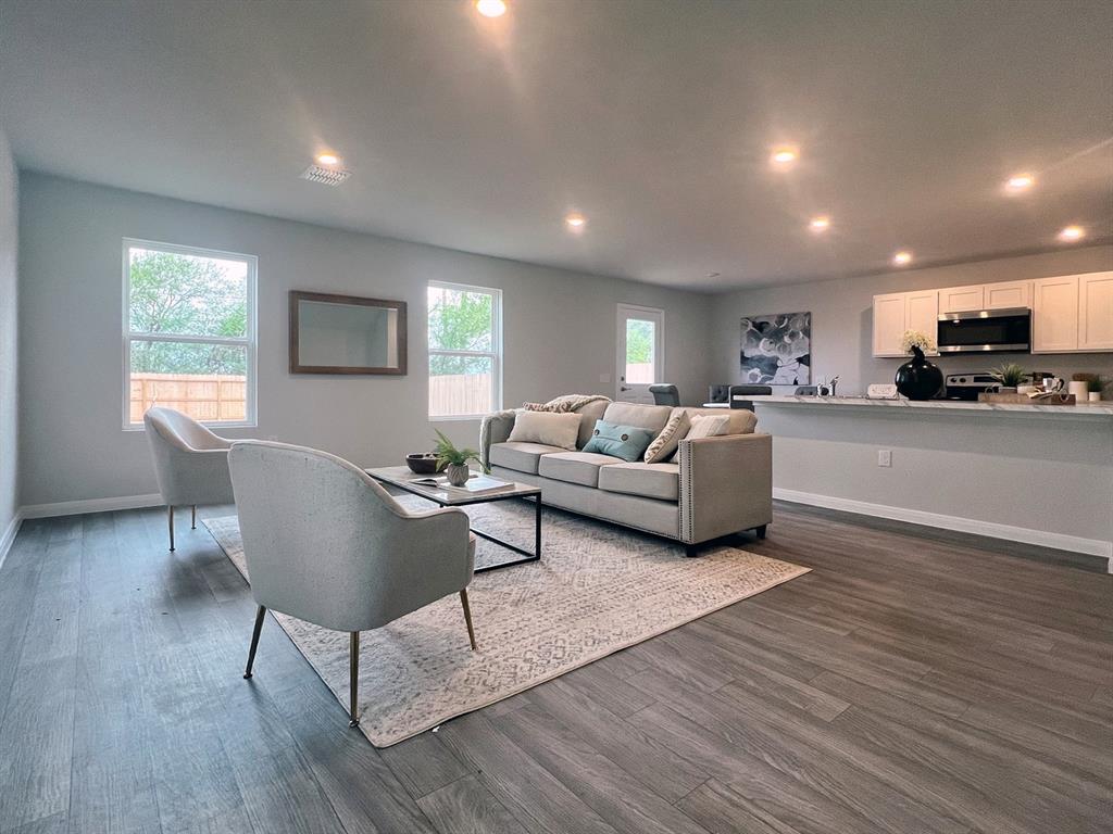 346 Azalea Trail Granbury, TX 76048 - Photo 5 of 11 a living room with furniture and a wooden floor