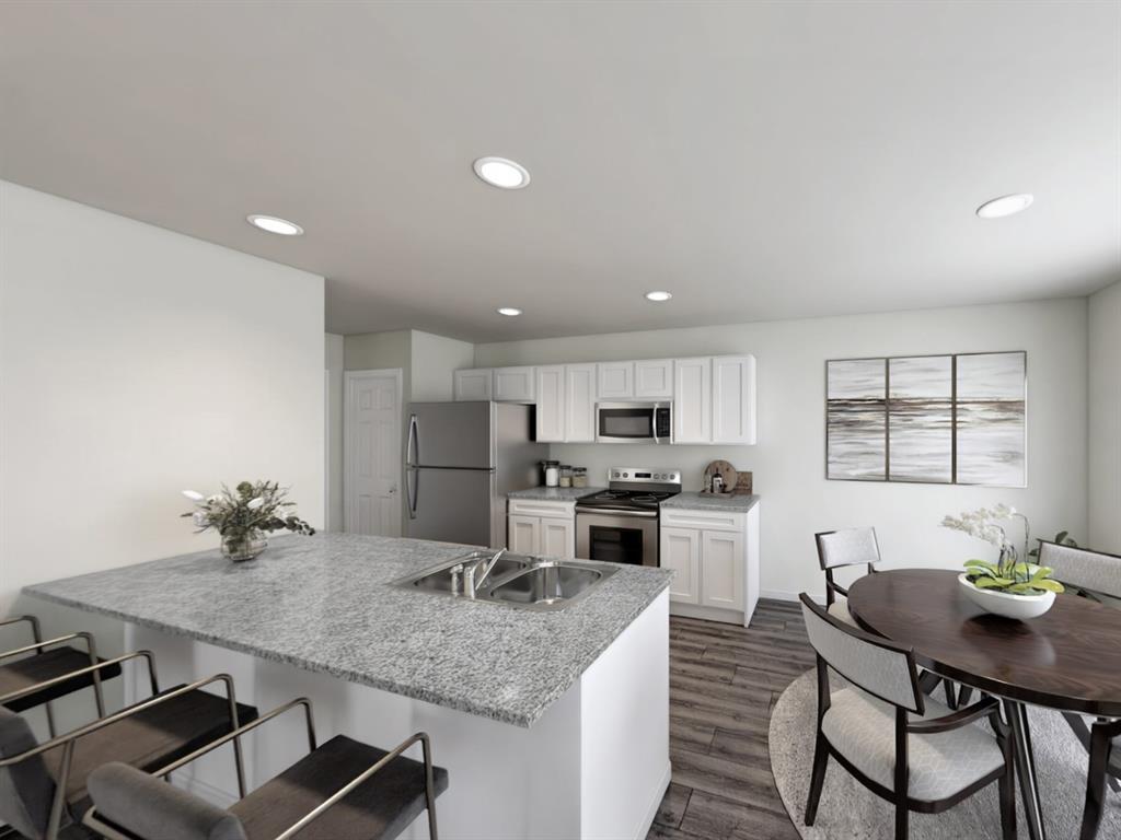 346 Azalea Trail Granbury, TX 76048 - Photo 8 of 11 a kitchen with stainless steel appliances a kitchen island hardwood floor sink stove dining table and chairs