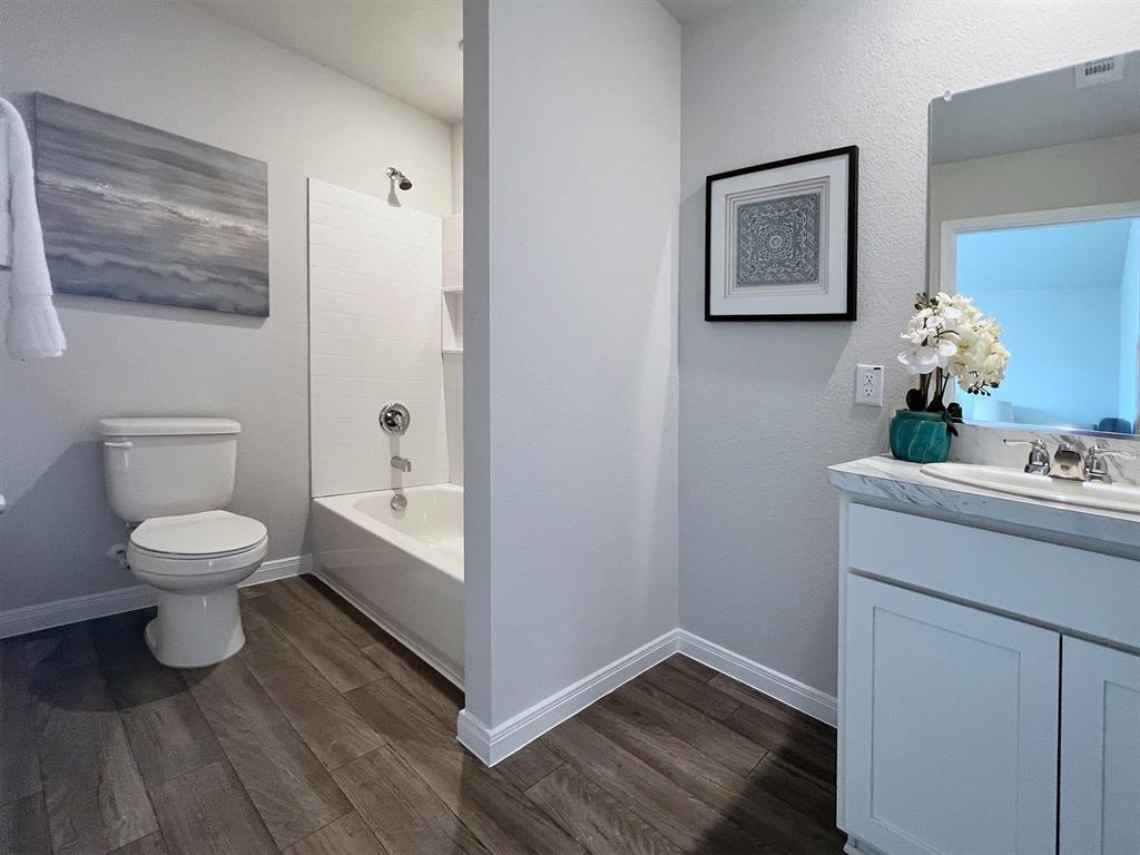 346 Azalea Trail Granbury, TX 76048 - Photo 9 of 11 a bathroom with a toilet and a shower