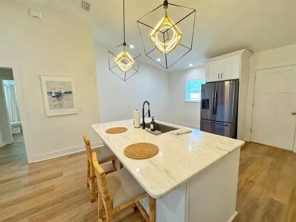 a kitchen with a table chairs and a refrigerator