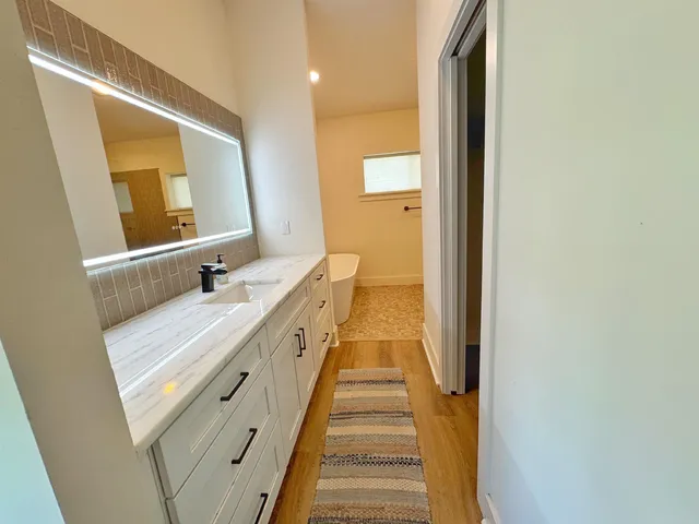 a spacious bathroom with a double vanity sink and a mirror