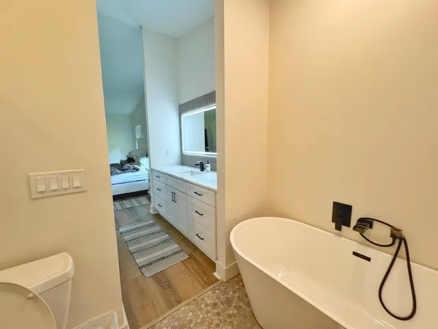 a bathroom with a granite countertop sink and a mirror
