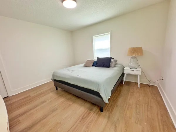 a bedroom with a bed and window